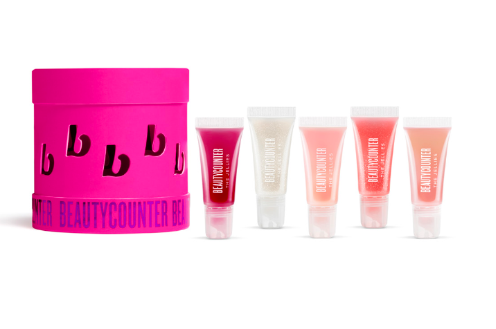 5 Holiday packaged jellies next to a pink cylindrical box